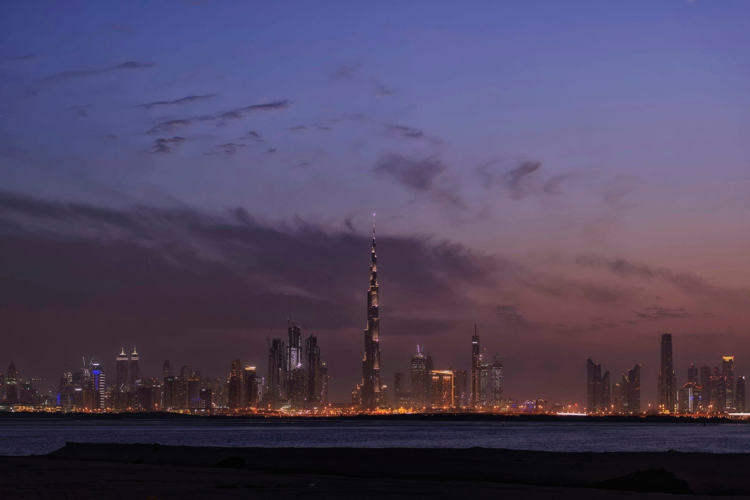 The Dubai skyline across the water at dusk